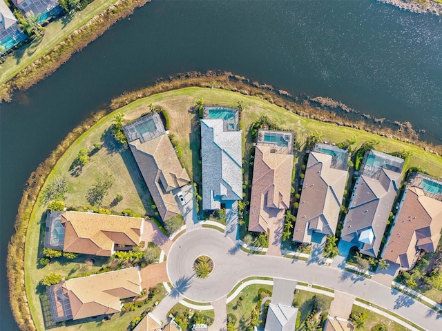 drone / aerial view with a residential view and a water view