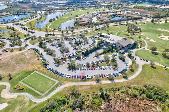 bird's eye view with a water view and view of golf course