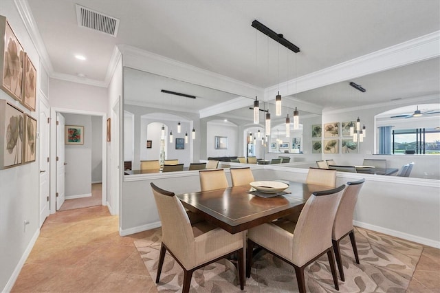 dining area featuring visible vents, ornamental molding, a ceiling fan, arched walkways, and light tile patterned floors