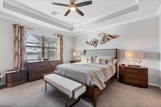 bedroom featuring visible vents, a raised ceiling, light carpet, and crown molding