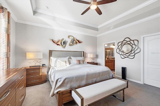 bedroom featuring ensuite bath, a tray ceiling, multiple windows, and light carpet