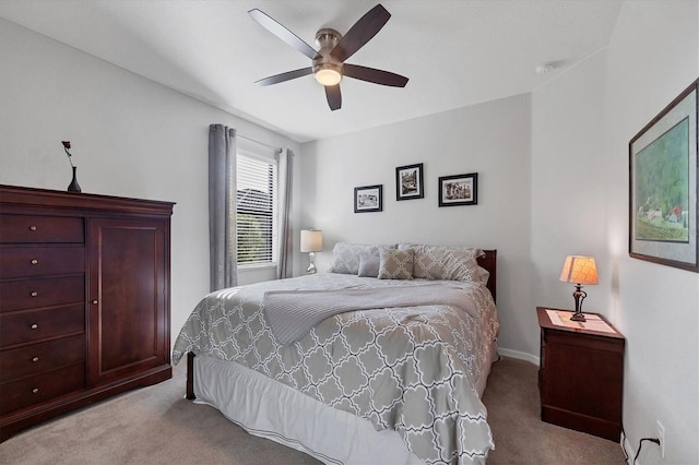 bedroom featuring a ceiling fan and light colored carpet