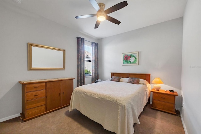 carpeted bedroom with baseboards and ceiling fan