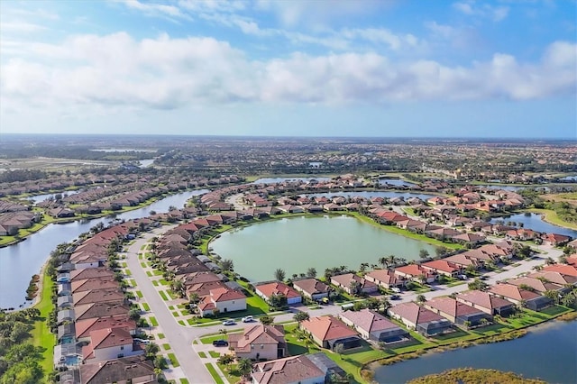 drone / aerial view featuring a residential view and a water view