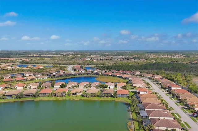 drone / aerial view with a residential view and a water view