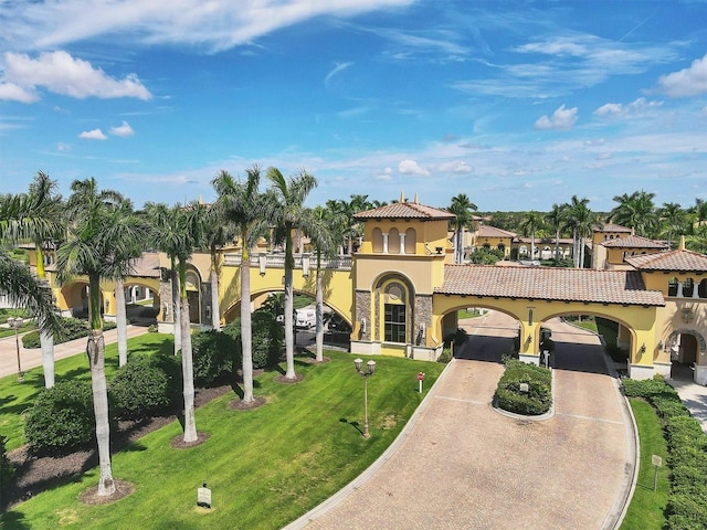 mediterranean / spanish-style house featuring a front yard, stucco siding, concrete driveway, a garage, and a tile roof