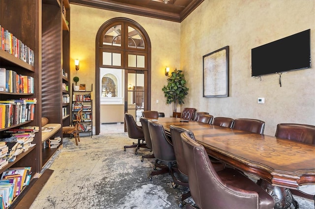 office featuring a towering ceiling and crown molding