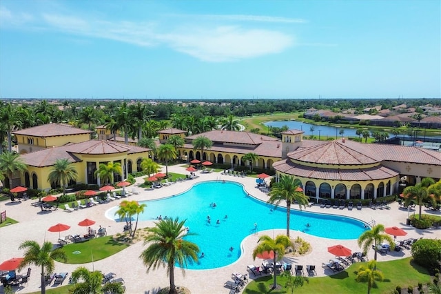 community pool featuring a water view and a patio area