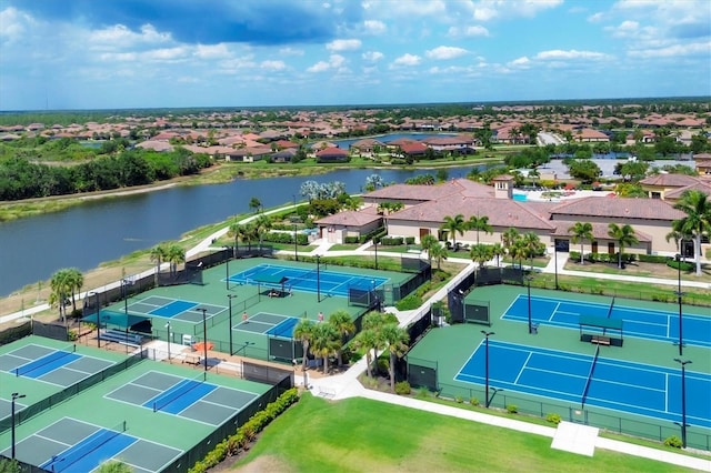 drone / aerial view featuring a residential view and a water view