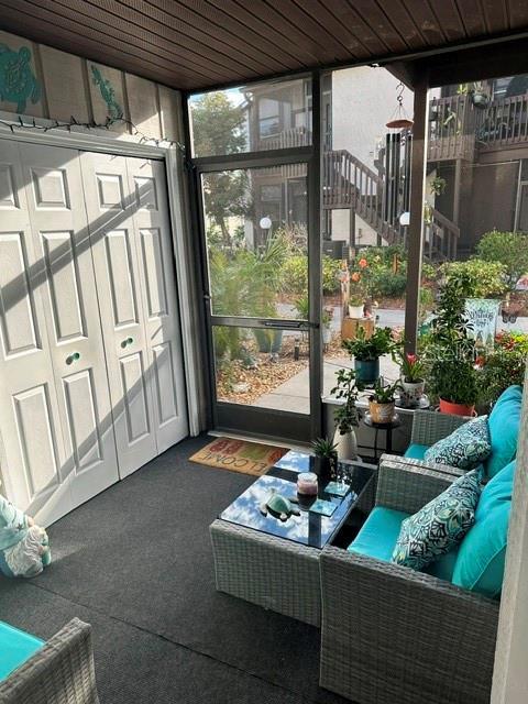 sunroom featuring wood ceiling