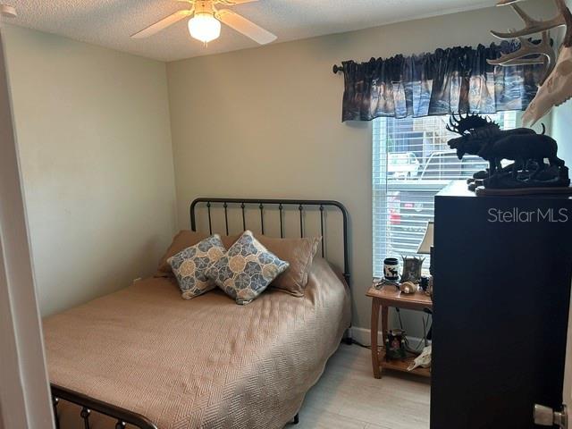 bedroom featuring a textured ceiling and ceiling fan