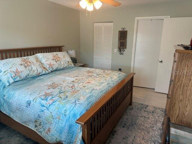 bedroom with wood finished floors and a ceiling fan