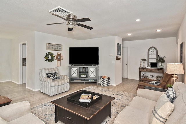 living area with a ceiling fan, wood finished floors, visible vents, baseboards, and recessed lighting