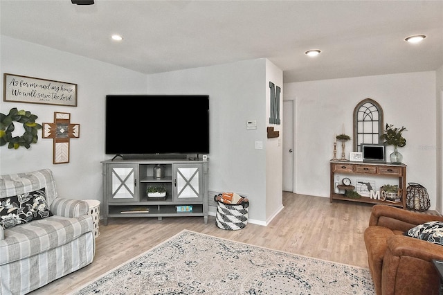 living room with recessed lighting, baseboards, and wood finished floors