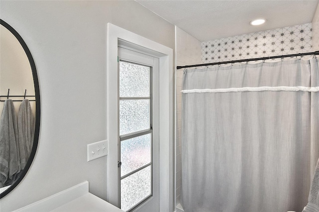 full bath with a shower with curtain and plenty of natural light