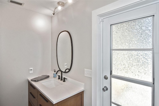 bathroom featuring a wealth of natural light, visible vents, and vanity