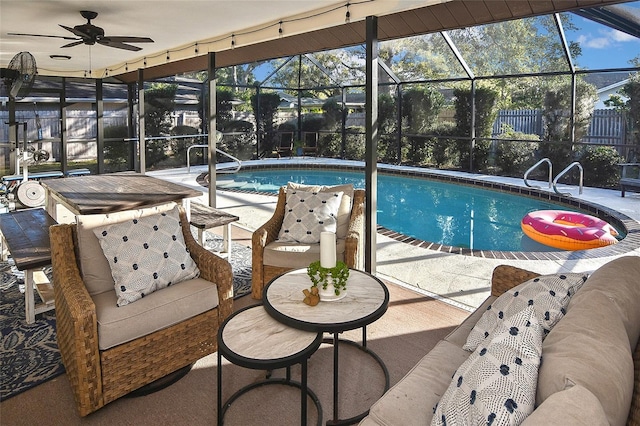 pool with glass enclosure, a patio, a ceiling fan, and fence