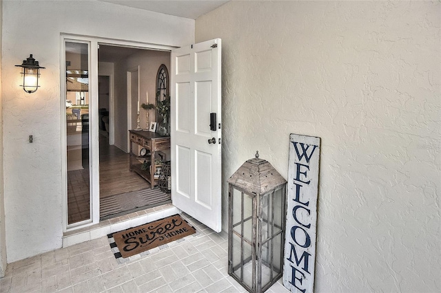 property entrance with stucco siding