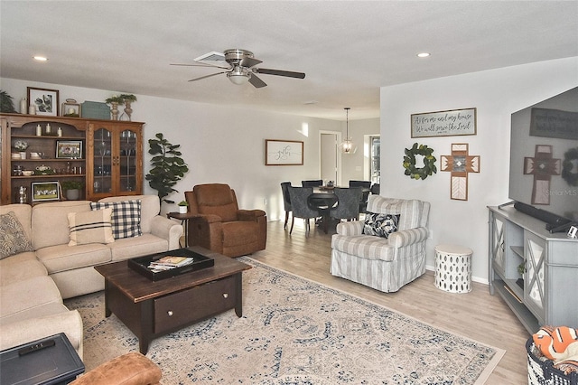 living room featuring ceiling fan, baseboards, wood finished floors, and recessed lighting