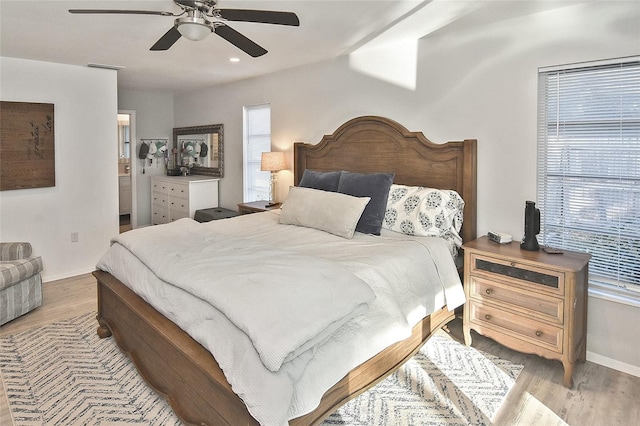 bedroom featuring connected bathroom, ceiling fan, baseboards, recessed lighting, and wood finished floors