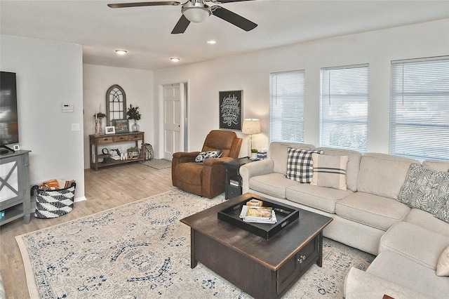 living room with a ceiling fan, recessed lighting, and light wood-style floors