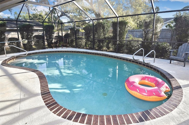 pool featuring a patio area, a lanai, and fence