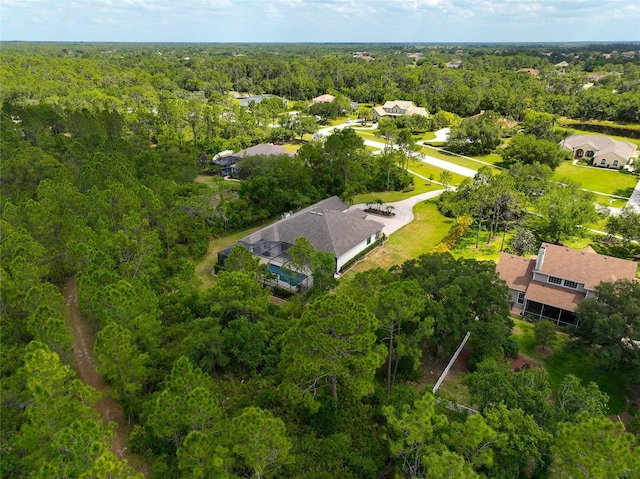 birds eye view of property featuring a view of trees