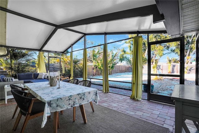 sunroom / solarium with lofted ceiling with beams