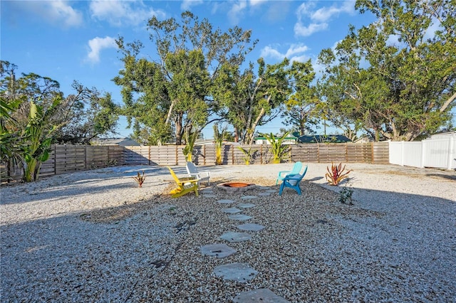 view of yard with a fire pit and a fenced backyard