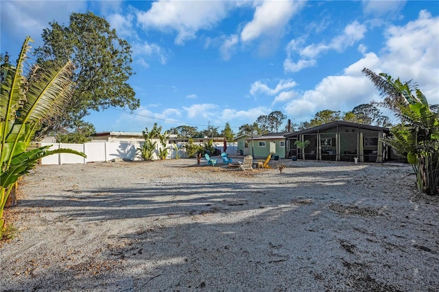view of yard featuring a sunroom and fence