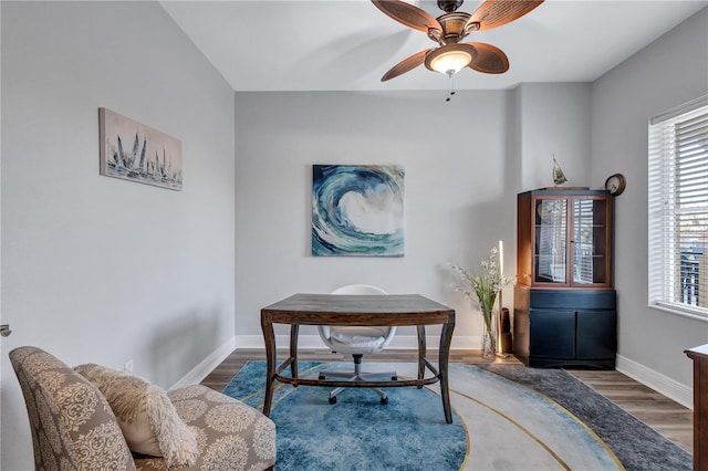 office with ceiling fan, baseboards, and wood finished floors