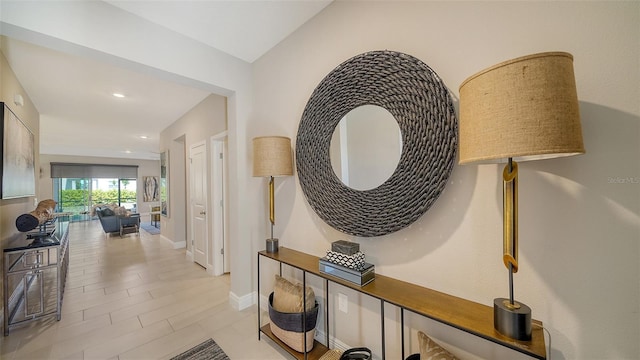 corridor with recessed lighting and baseboards