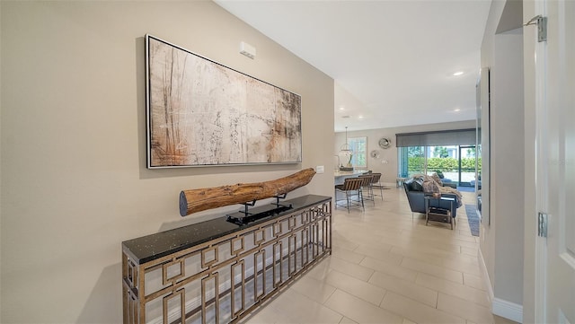 hallway featuring recessed lighting and baseboards