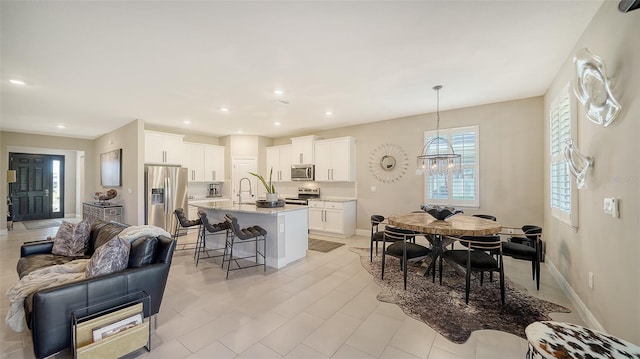 dining area with recessed lighting, baseboards, and a chandelier