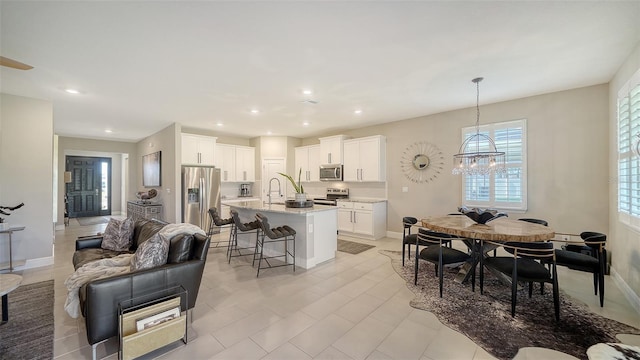 interior space featuring recessed lighting, baseboards, and an inviting chandelier