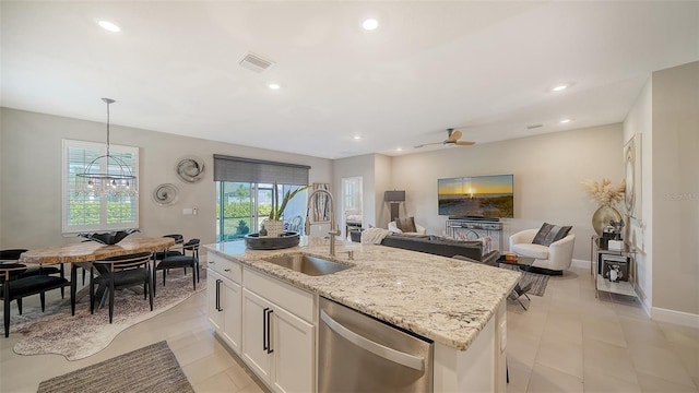 kitchen with a sink, white cabinetry, light stone countertops, dishwasher, and ceiling fan