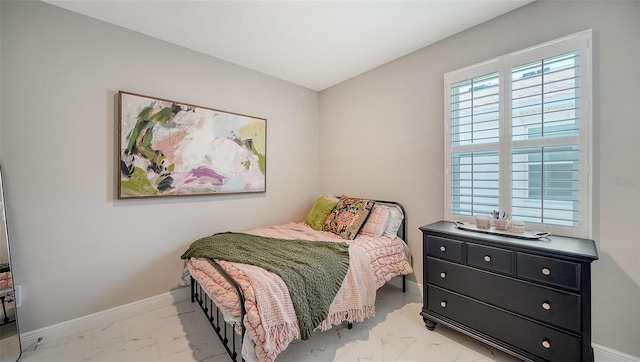 bedroom featuring baseboards and marble finish floor