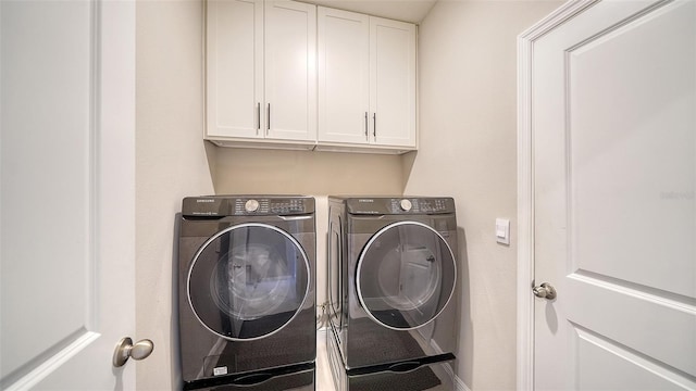 laundry room featuring cabinet space and washing machine and clothes dryer