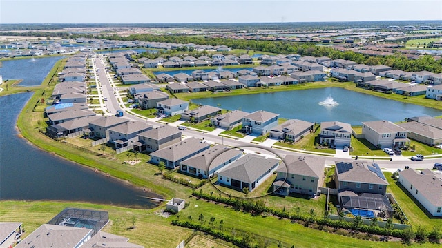 drone / aerial view featuring a residential view and a water view