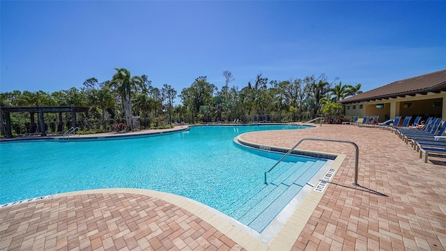 pool featuring a patio and a pergola