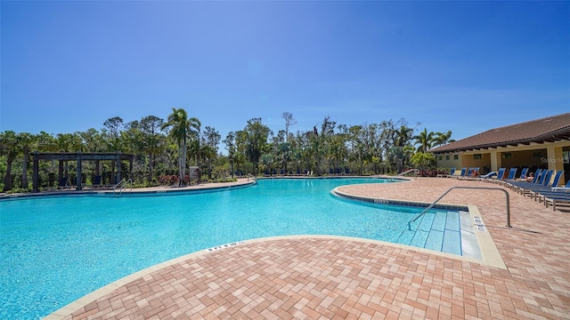 pool with a patio area and a pergola