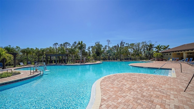 pool with a patio and a pergola