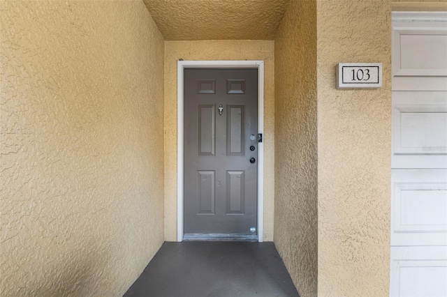 view of exterior entry with stucco siding