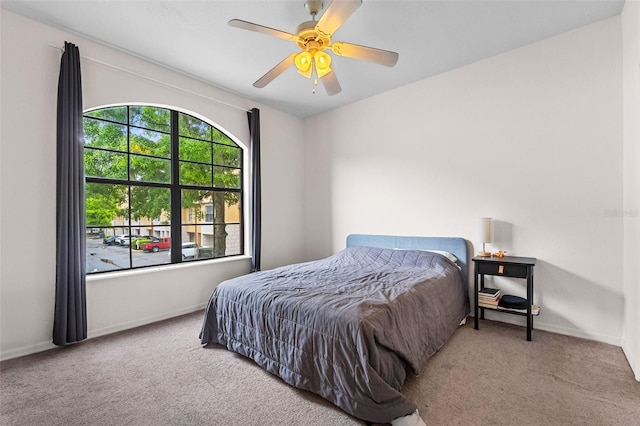 bedroom with baseboards, a ceiling fan, and carpet flooring