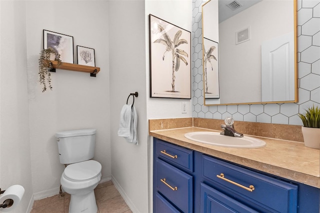 bathroom featuring visible vents, toilet, vanity, and tile patterned flooring