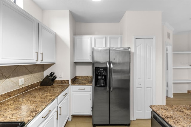 kitchen with dark stone countertops, visible vents, white cabinets, appliances with stainless steel finishes, and backsplash