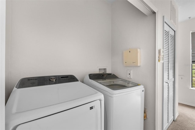 washroom with laundry area, washing machine and dryer, and carpet floors