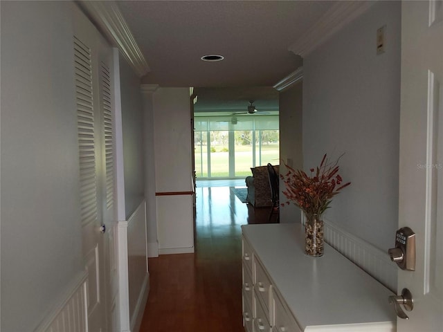 hallway featuring dark wood-style floors and crown molding