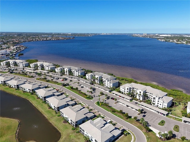 drone / aerial view featuring a residential view and a water view