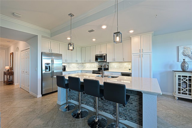 kitchen featuring backsplash, stainless steel appliances, crown molding, and a sink